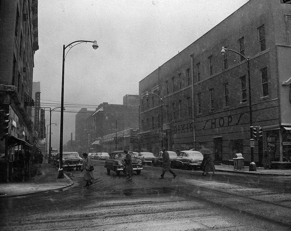 Springfieldians cross St. Louis Street near the public square during a blizzard, January 10, 1955. Image from the From the Darkroom collection.