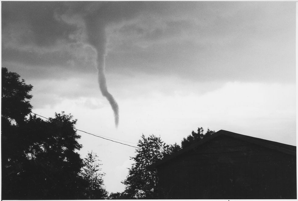 A funnel cloud forming above Ozark, Missouri, July 16, 1988. Photographed by Kent Thompson for the Springfield News-Leader. Image from the From the Darkroom collection.