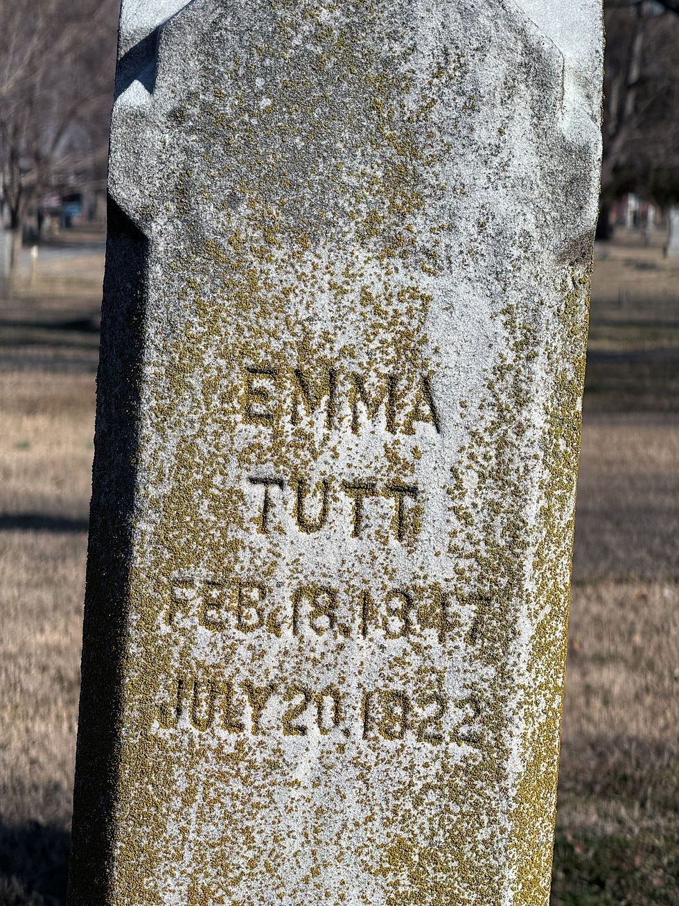 Emma Tutt's side of the Tutt family headstone. In this photo, it is crusted with lichen. Text reads:
Emma Tutt
Feb. 18. 1847
July 20. 1922