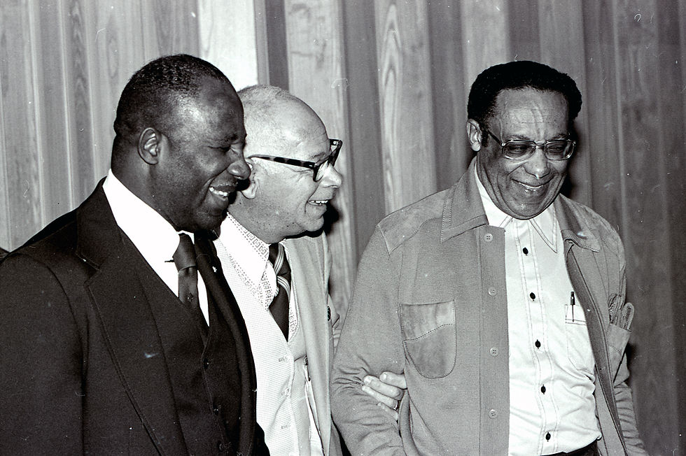 The Reverends Rufus Walker, Vance Jenkins, and David Hutchinson, all older African-American men, laugh together.