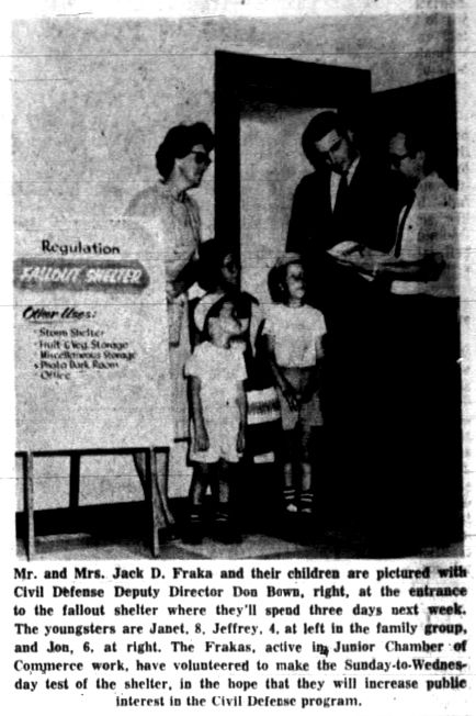 A clipping from the August 10, 1960 issue of the Springfield Leader and Press. The Fraka family and Civil Defense Deputy Director Don Bown are photographed at the entrance of Ralph Manley's fallout shelter. Text reads: "Mr. and Mrs. Jack D. Fraka and their children are pictured with Civil Defense Deputy Director Don Bown, right, at the entrance to the fallout shelter where they'll spend three days next week. The youngsters are Janet, 8, Jeffrey, 4, at left in the family group, and Jon, 6, at right. The Frakas, active in Junior Chamber of Commerce work, have volunteered to make the Sunday-to-Wednesday test of the shelter, in the hope that they will increase public interest in the Civil Defense Program."
