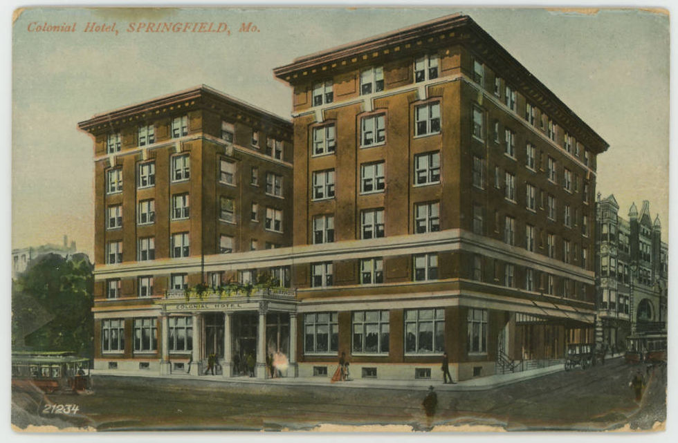 A postcard depicting the Colonial Hotel in Downtown Springfield. The hotel has a brown facade with two towers. The entrance is flanked with Greco-Roman columns. A streetcar is passing in front of the hotel.