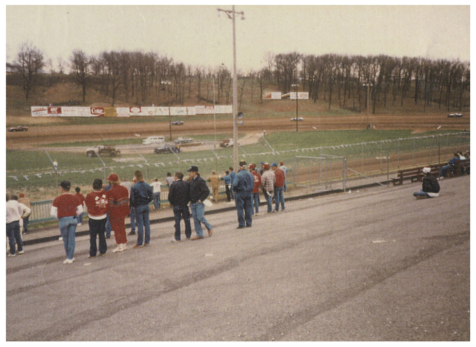 Spectators watch racers go around the dirt track at I-44 Speedway in Lebanon, Missouri.