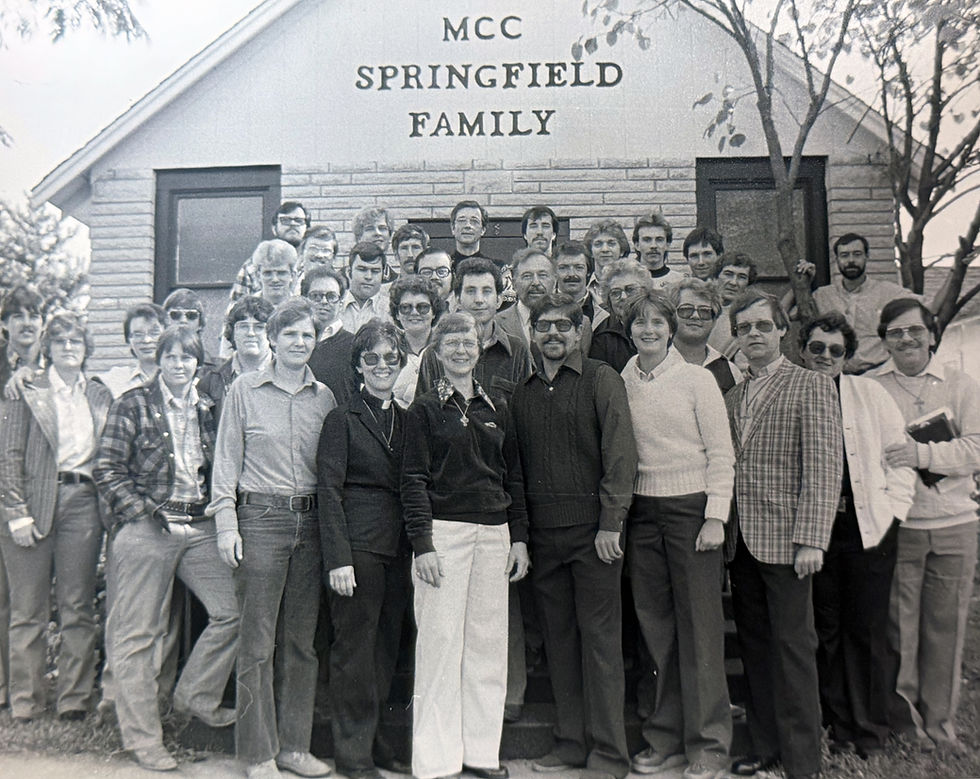 A group photograph of the Metropolitan Community Church's congregation in Springfield. The group is composed of about two dozen men and women of various ages.