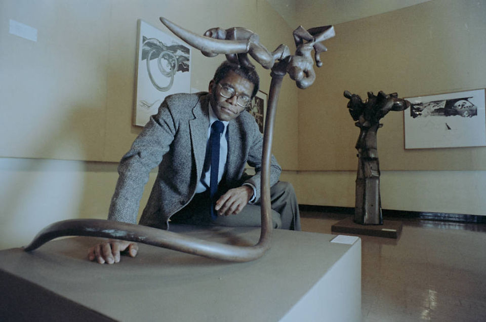 Richard Hunt with his sculpture, "Coil."