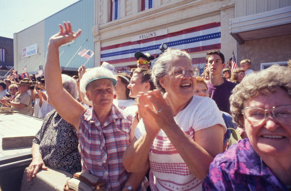 Three older women (Ruth Burkey, Evelyn Parkhurst, and Marcella Letterman) watch from the sidelines of Marshfield's 1991 Fourth of July parade.
