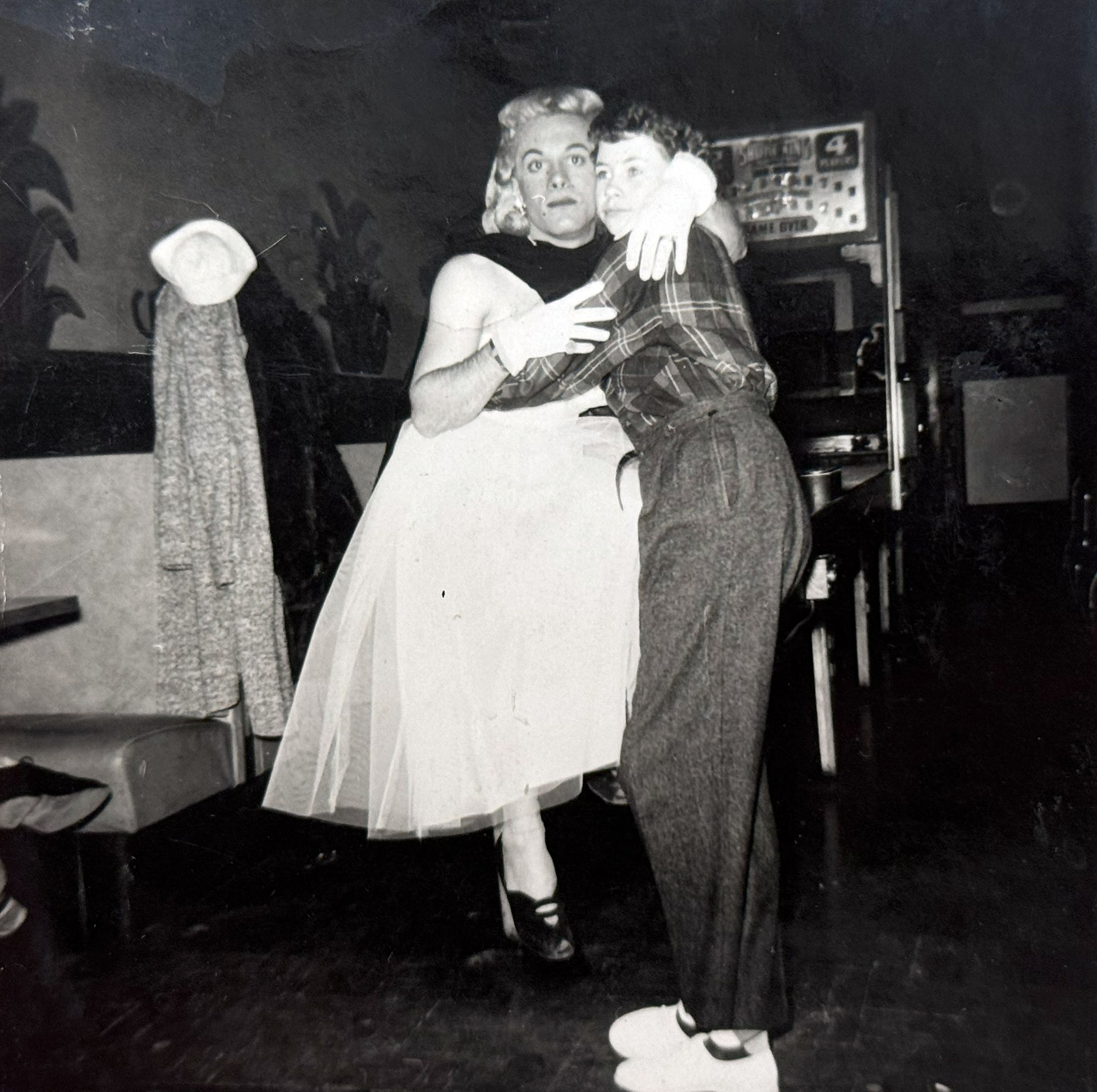 A man in drag and a woman dance at Lucille's.