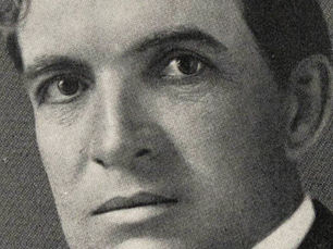 Tightly cropped black and white portrait of a young John T. Woodruff. Woodruff has a heavy brow and dark eyes.