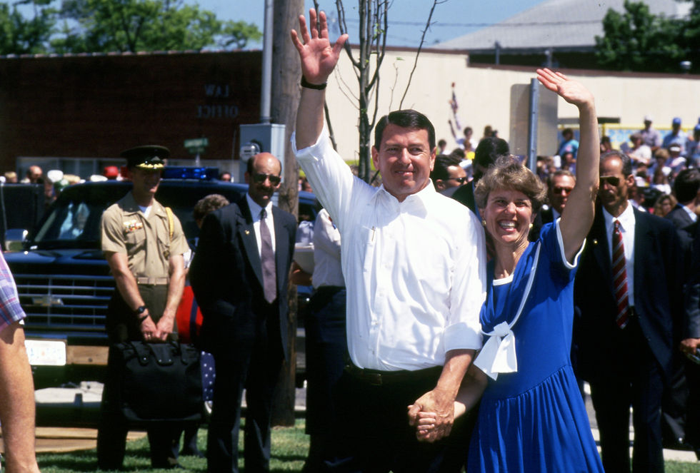 Governor John Ashcroft and his wife Janet wave after arriving in Marshfield for the 1991 Fourth of July parade.