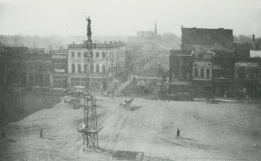 A photograph of Springfield's public square as it appeared in 1900. Gottfried Tower stands in the center of the square. A replica of the Statue of Liberty is on top of the tower.