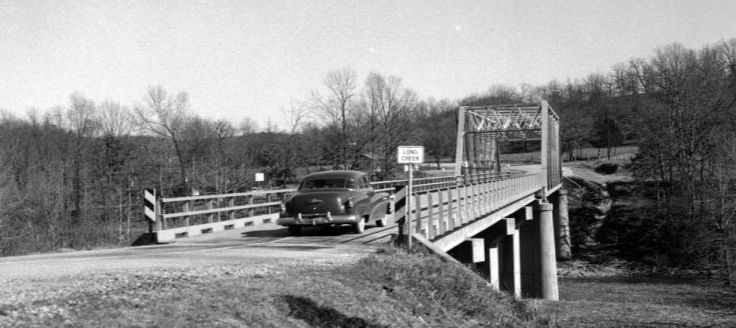 A car drives over the new Long Creek Bridge.