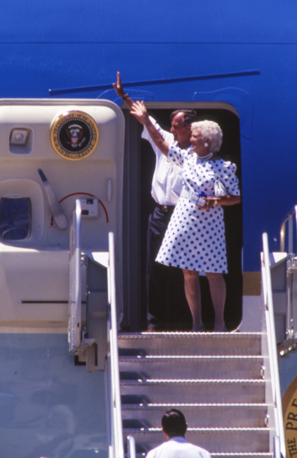 George H. W. Bush and First Lady Barbara Bush wave before boarding Air Force One.