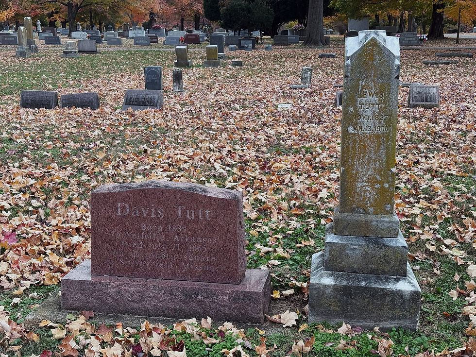 The gravestones of Davis and Lewis Tutt at Maple Park Cemetery. Davis's headstone is newer and constructed of polished granite. Text on Davis's headstone reads: "Davis Tutt. Born 1839 In Yellville Arkansas. Died July 21, 1865 on the public square in Springfield, Missouri." Lewis's monument, an obelisk, is covered in lichen. Text on Lewis's gravestone reads: "Lewis Tutt. Nov 1 1827. Jan. 13. 1900."