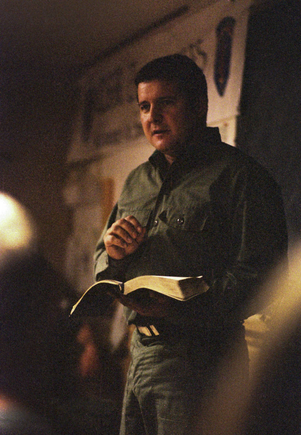 Jim Ellison of the Covenant, the Sword, and the Arm of the Lord reads from a Bible at the militia's compound, Zarepath-Horeb.