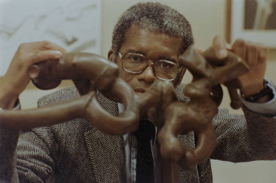 Richard Hunt with his sculpture, "Coil."