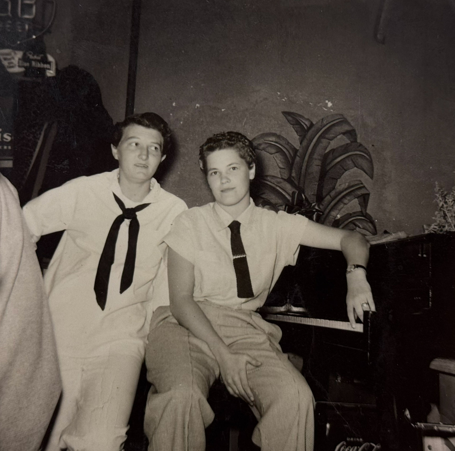 Two unidentified women sit at a piano at Lucille's.