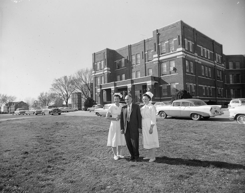 State Hospital superintendent Paul Barone stands with registered nurses Ruby Walker and Mary Bowlin outside of State Hospital No. 3 in Nevada, Missouri.