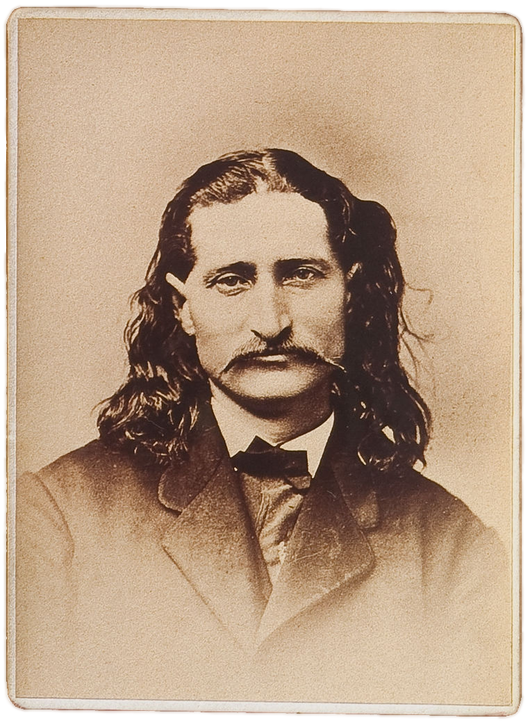 A sepia toned portrait of a man with long hair and a long mustache wearing a high collar and jacket with lapel. 