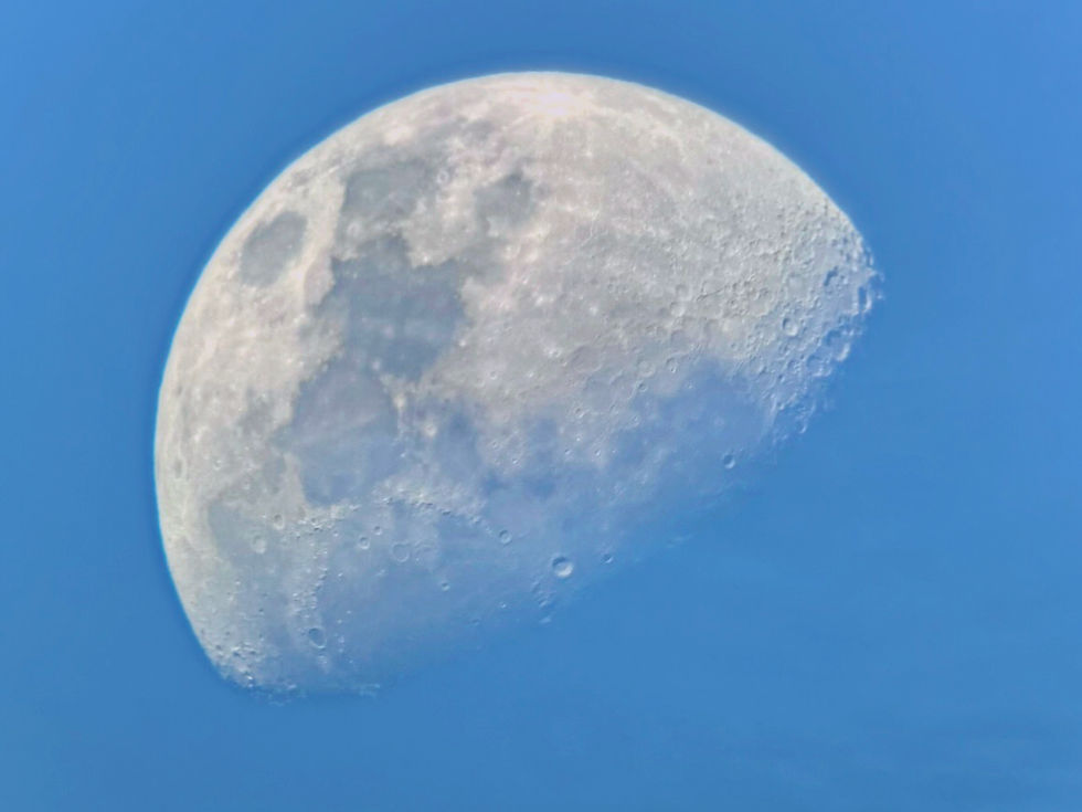 The waxing gibbous moon against a blue sky