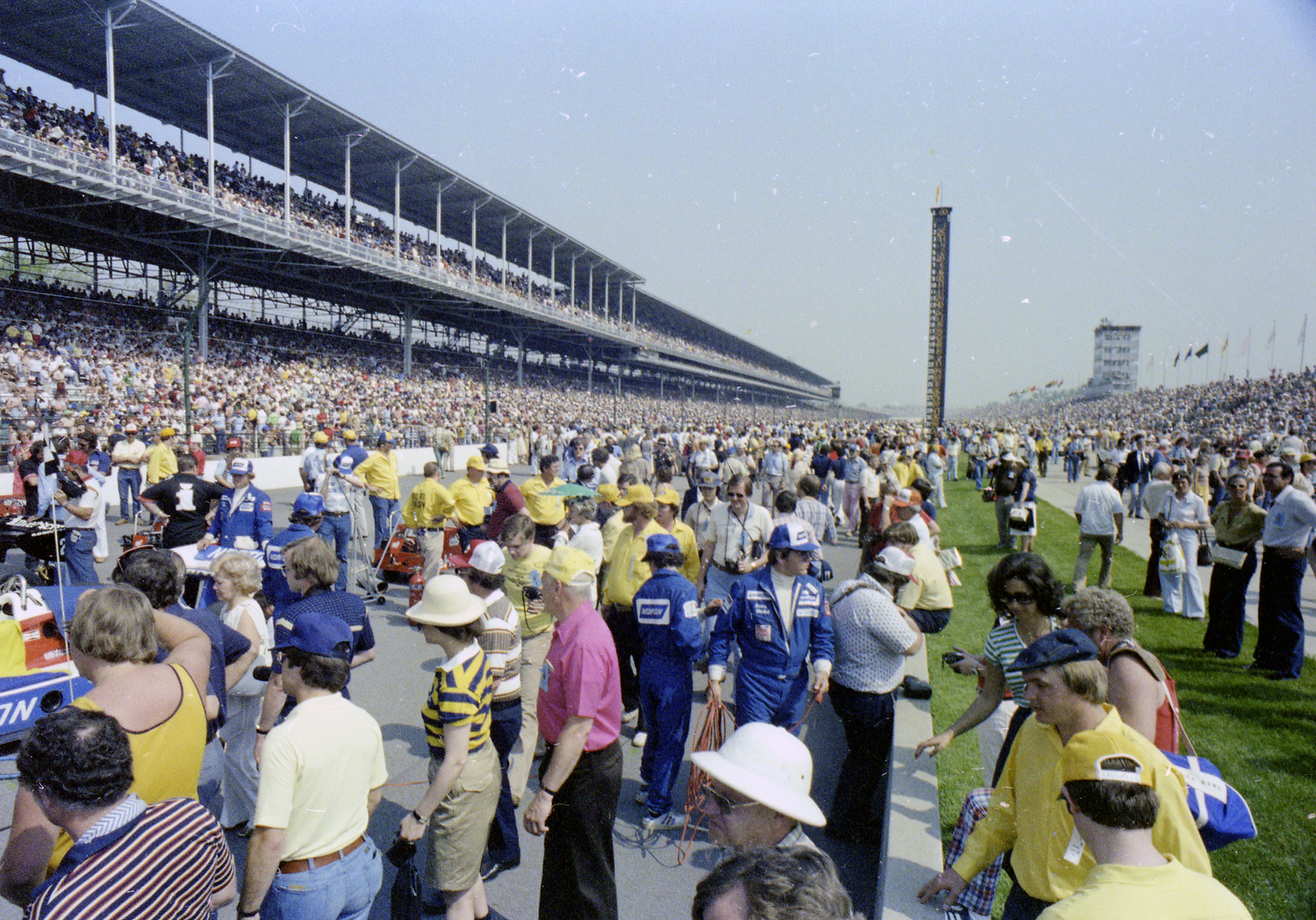 Moments before the 1978 Indianapolis 500, fans, drivers, and pit crew gather on the starting grid.