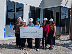 Arvest Reps and Library Staff with check