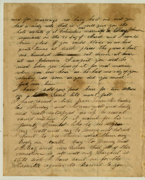 A stained yellowed letter written in black ink in leaning cursive.